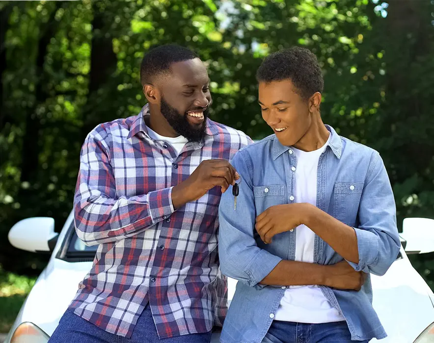 car battery shop - son and dad handing car keys